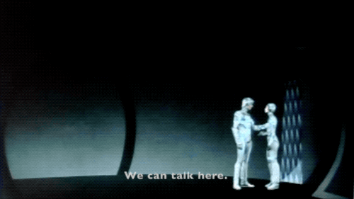 Tron and Yori are in her very plain gray quarters. She says: We can talk here. And watch this. Then she touches a panel on the wall, and the whole room becomes filled with colorful designs. She asks Tron: How's that? and he replies: It's beautiful.